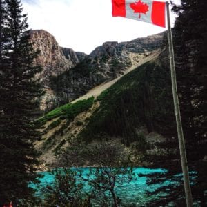 Peak through the trees at the azure blue waters of Morain Lake from your cabin window.