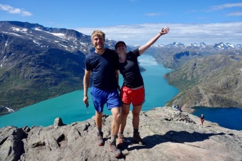 Norway. Couple on a peak above a deep fjord