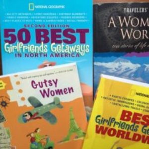 Gutsy Traveler: A close-up of several MB-Books travel guidebooks, including "50 Best Girlfriends Getaways in North America" and "Traveler's Tales A Woman’s World.